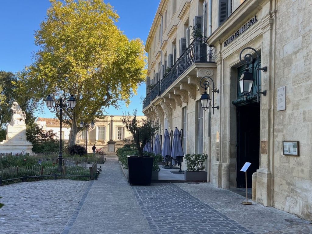 Place de la Canourgue in Montpellier’s historic Écusson district, with elegant 17th-century mansions, wrought-iron balconies, and a small formal garden
