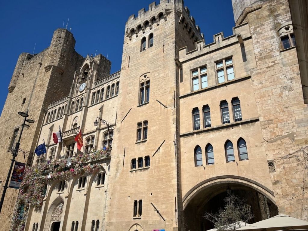 Neo-Gothic façade of the Archbishop's Palace in Narbonne, flanked by the Gilles Aycelin keep and the Saint-Martial Tower